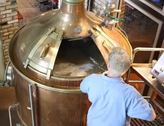 Photo du propriétaire de la micro-brasserie en train de brasser une bière artisanale dans l'atelier de la micro-brasserie située à Fougères en Ille-et-Vilaine en Bretagne